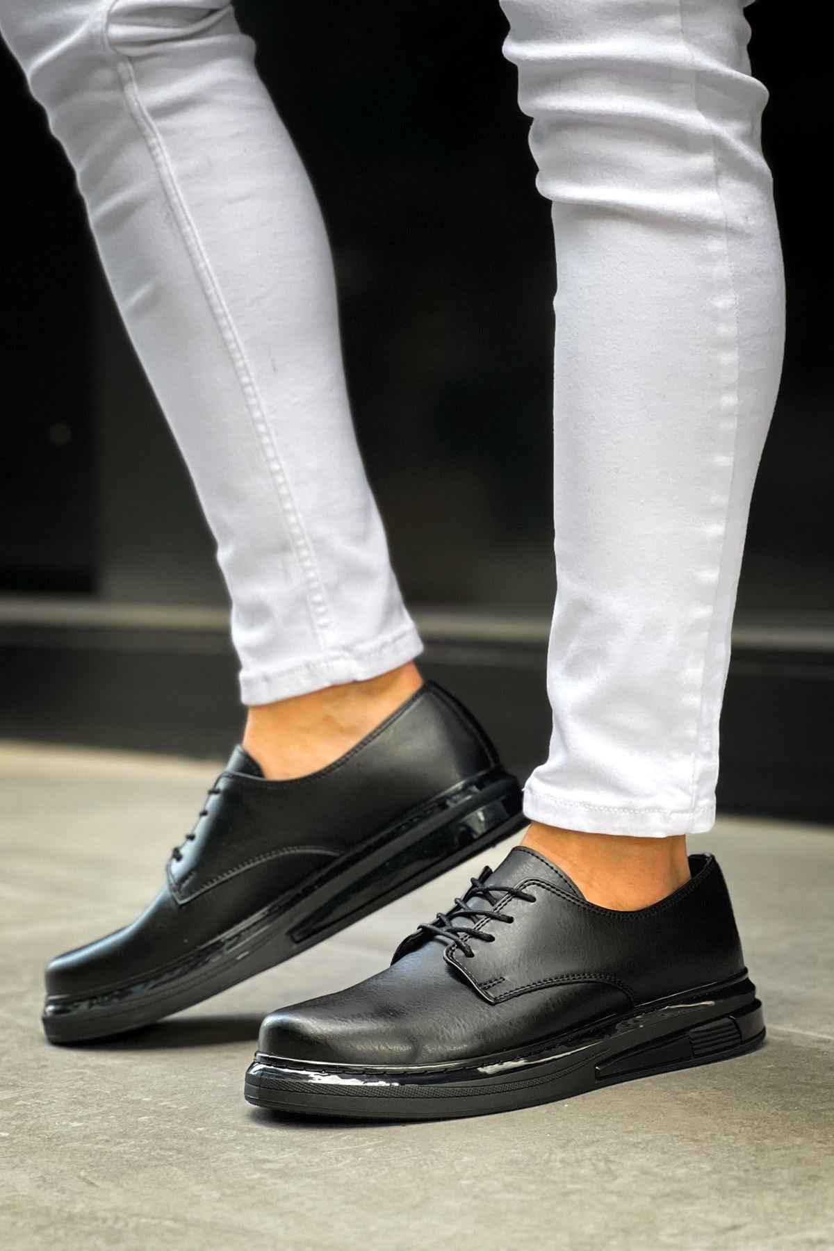 Men's classic black lace-up dress shoes, side view with low-profile sole