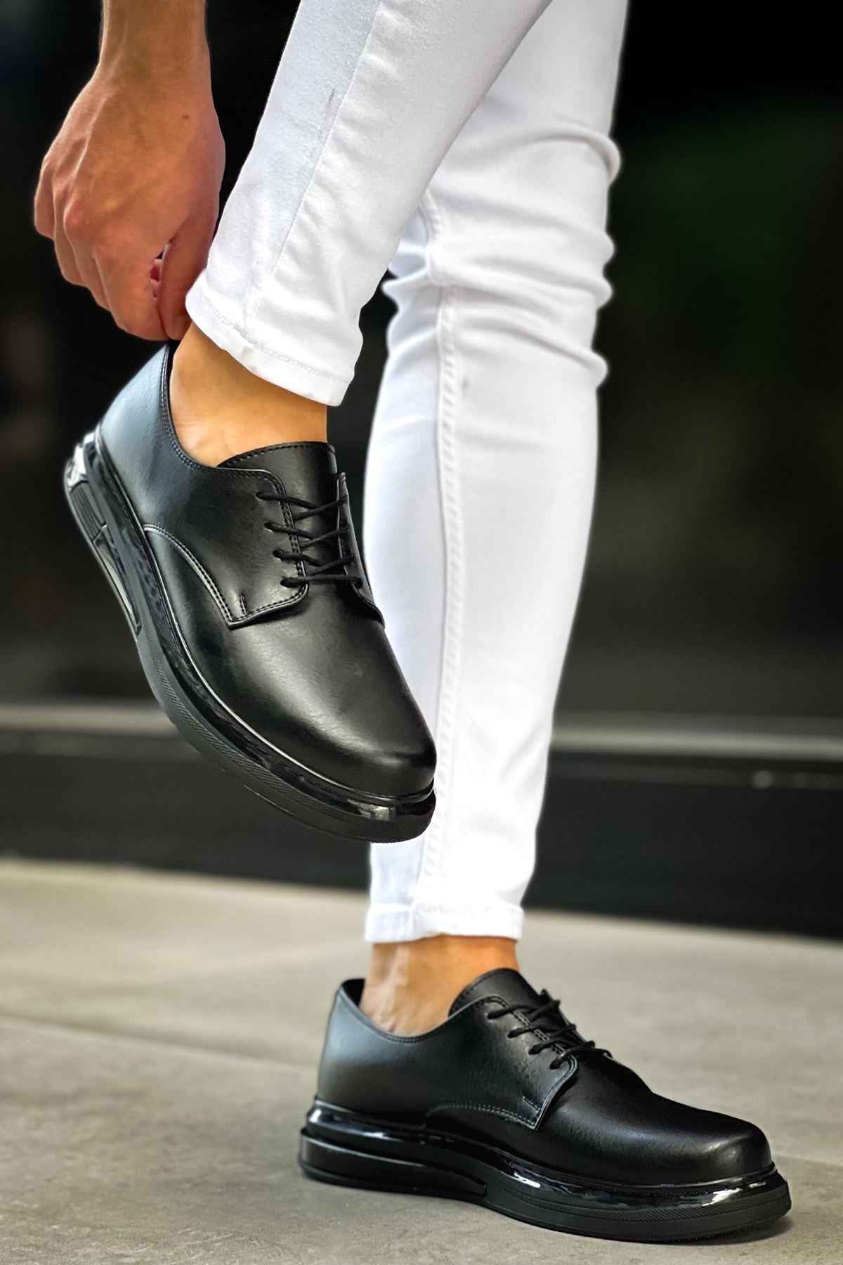 Men's classic black lace-up shoes with stitched detail and cushioned sole