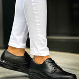 Men's classic black lace-up shoes, angled side view with textured outsole
