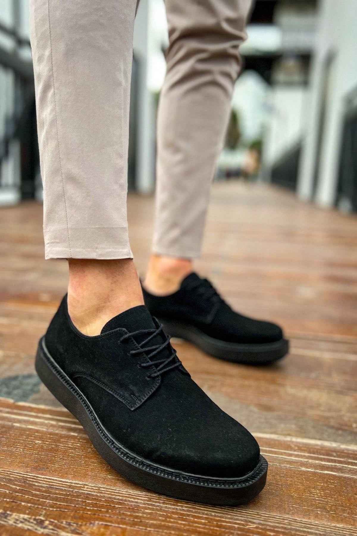 Black suede lace-up shoes with textured seam and rubber sole