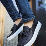 Men's black tassel loafers with white rubber sole