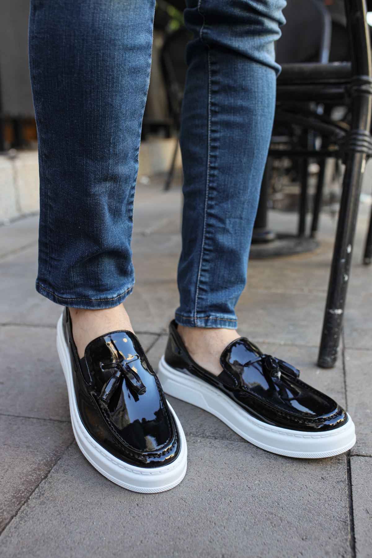 Men's black patent leather loafers with white rubber sole, front view
