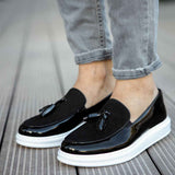 Black patent leather tassel loafers with white rubber sole