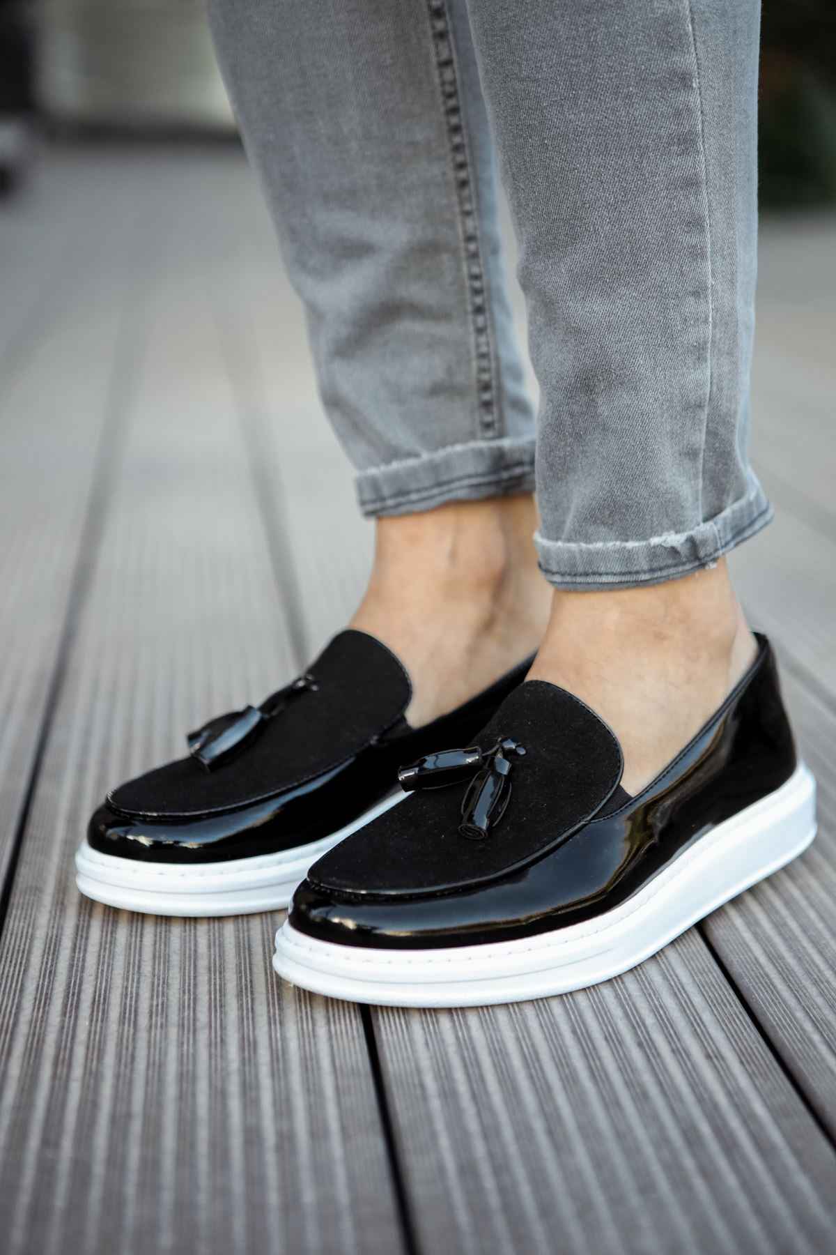 Black patent leather tassel loafers with white rubber sole