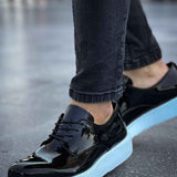 Men's black patent leather low-top sneakers with light blue outsole and lace-up design