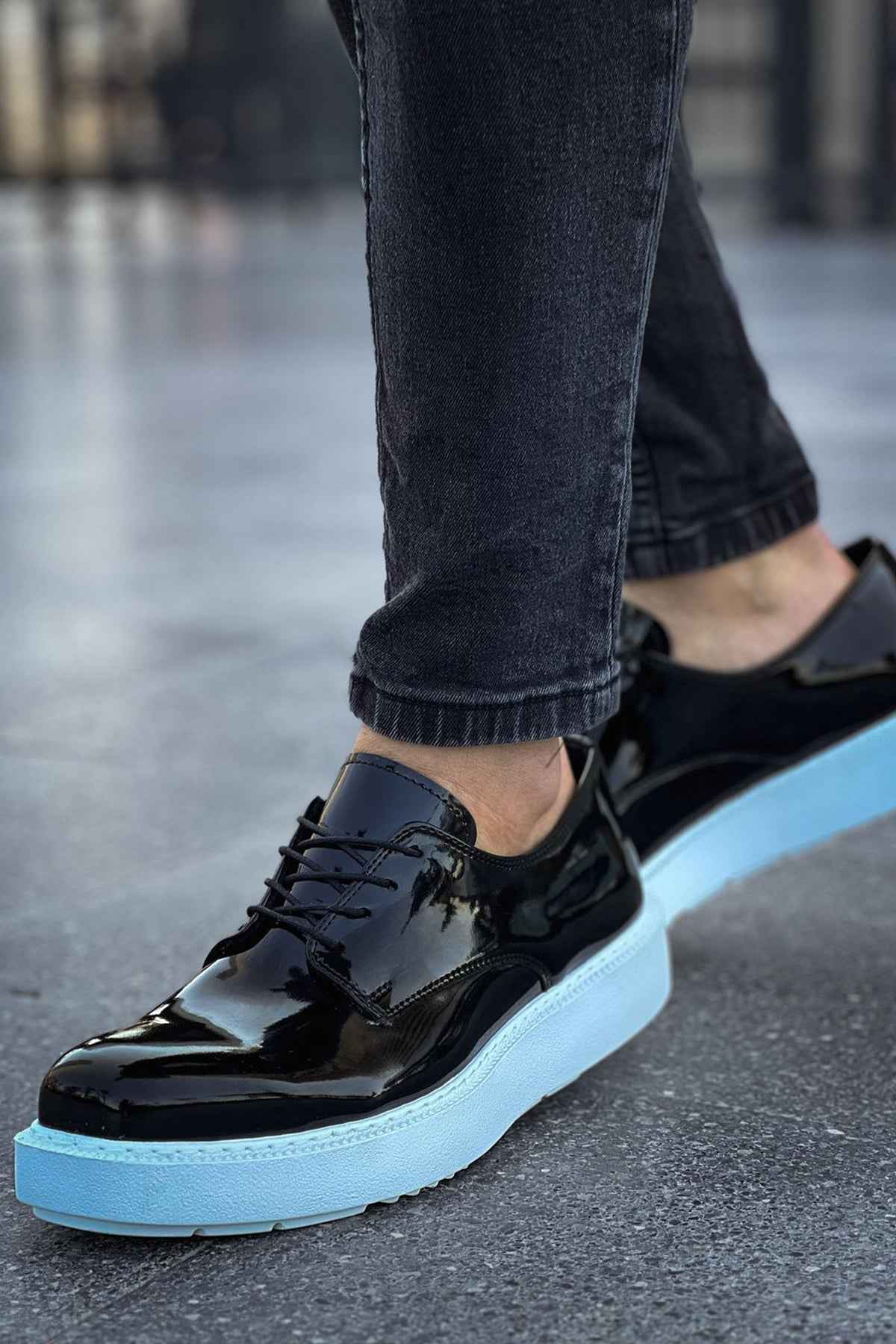 Men's black patent leather low-top sneakers with light blue outsole and lace-up design