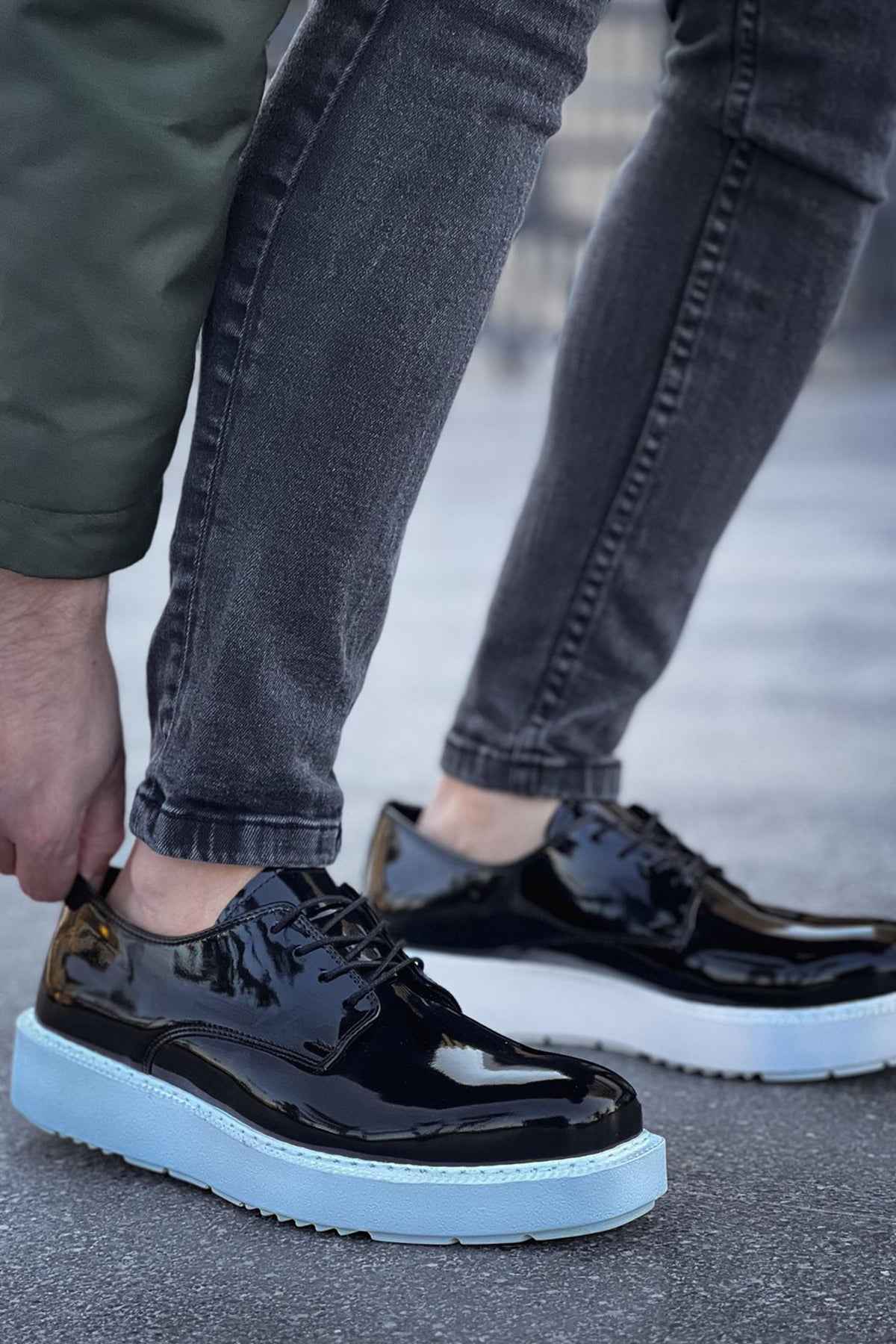 Men's black patent leather sneakers, side view, light blue sole and lace-up front