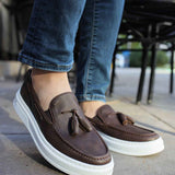 Brown loafers with tassel detail and slip-on design, white rubber sole.