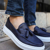 Navy suede tassel loafers with slip-on design and white rubber sole