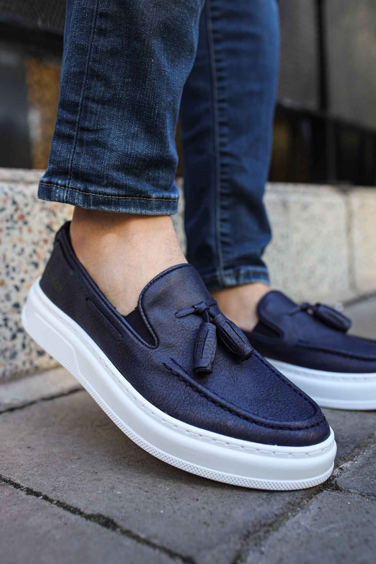 Navy suede tassel loafers with slip-on design and white rubber sole