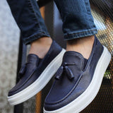 Navy suede loafers with tassel detail and white contrast rubber sole