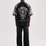 Black oversize men’s T-shirt with central back graphic and floral print sleeves