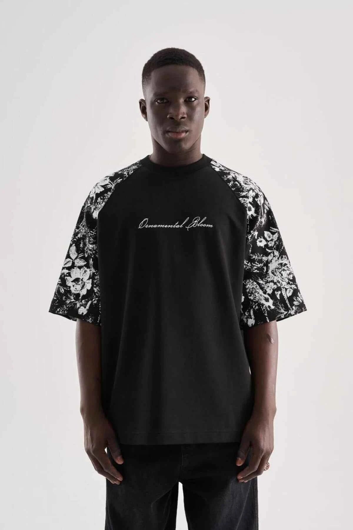 Black oversize men’s T-shirt with floral sleeve print and centered script graphic