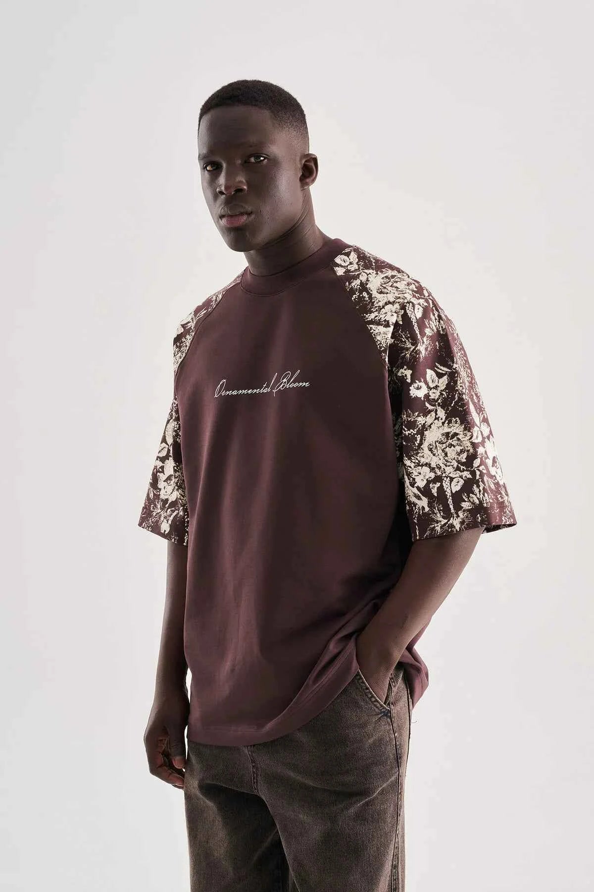 Brown oversize T-shirt with floral print sleeves and script logo on chest
