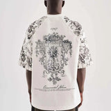 White oversized T-shirt with large black floral crest graphic on back