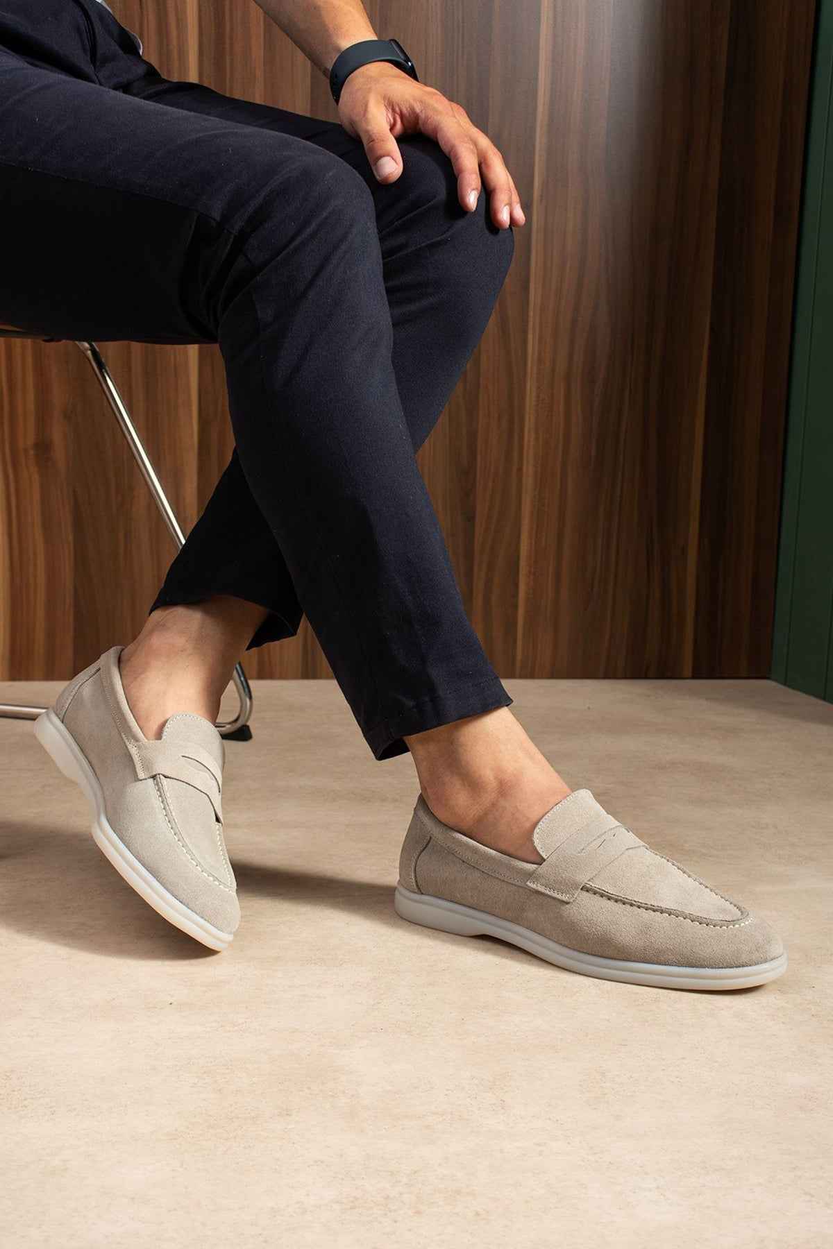 Beige leather loafers with slip-on upper and side seam stitching
