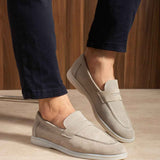 Beige leather loafers with moc-toe stitching and cushioned collar