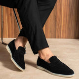 Black slip-on loafers, side view, white rubber sole