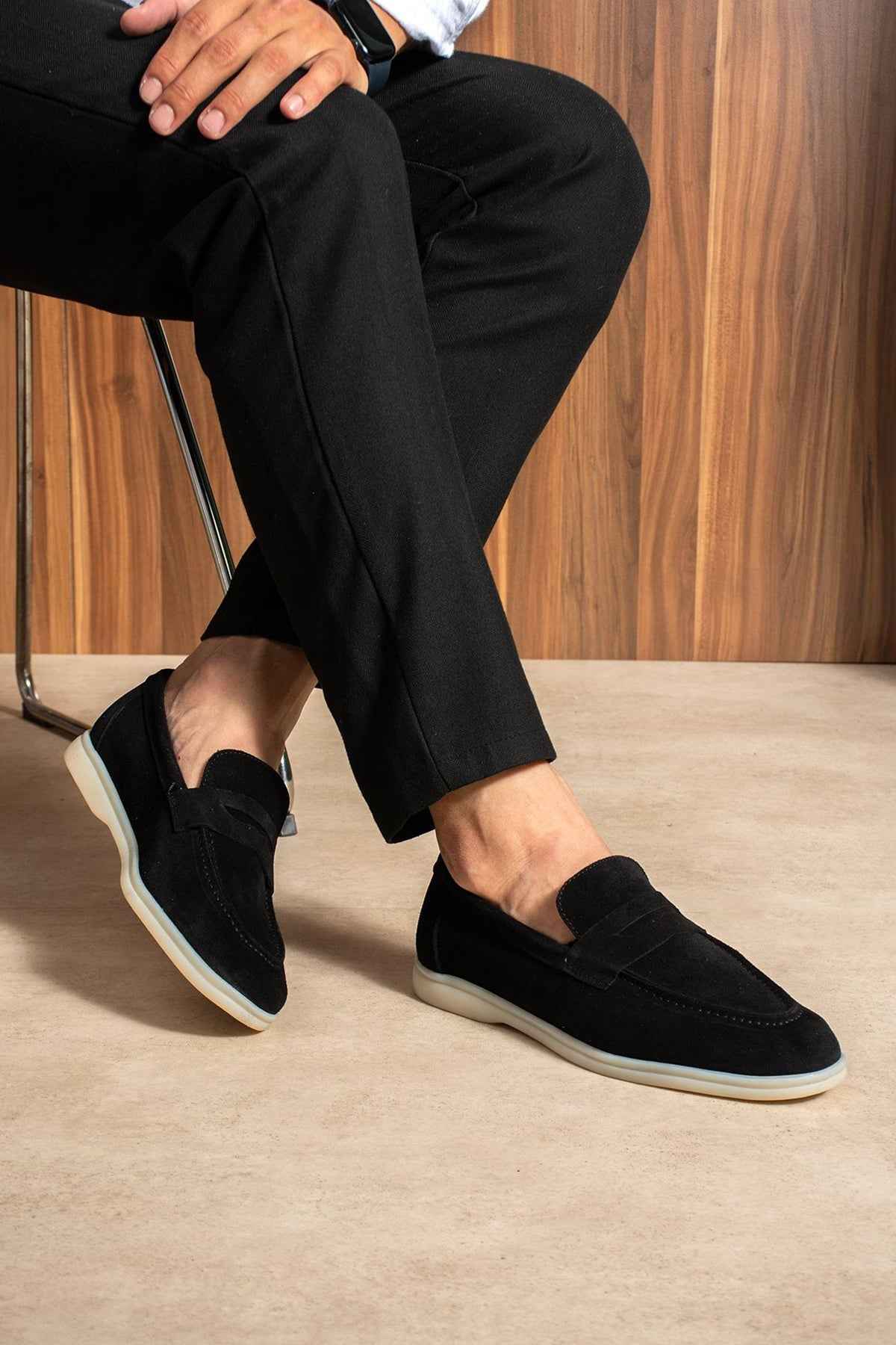 Black slip-on loafers, side view, white rubber sole