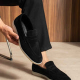 Black loafers with strap across top and cushioned collar