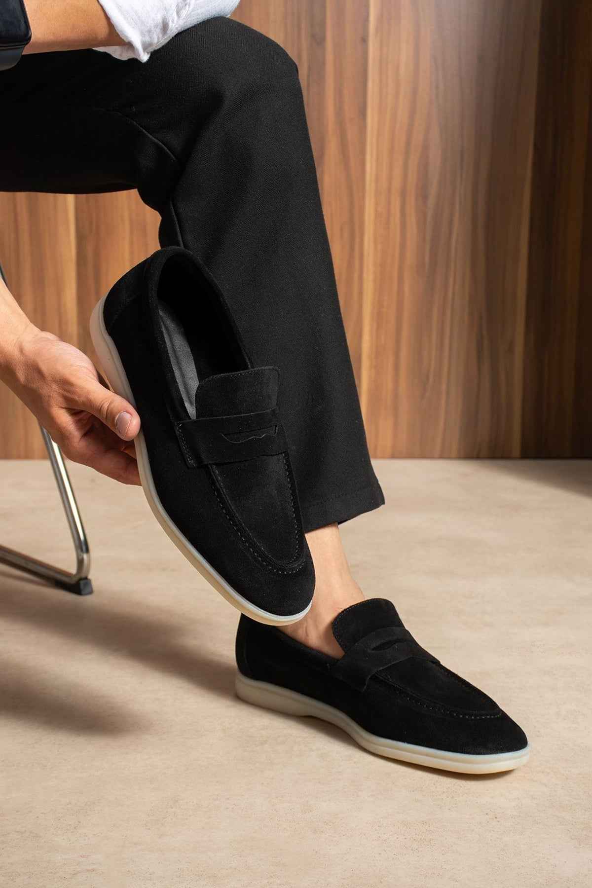 Black loafers with strap across top and cushioned collar