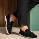 Black slip-on loafers with low profile and white sole edge