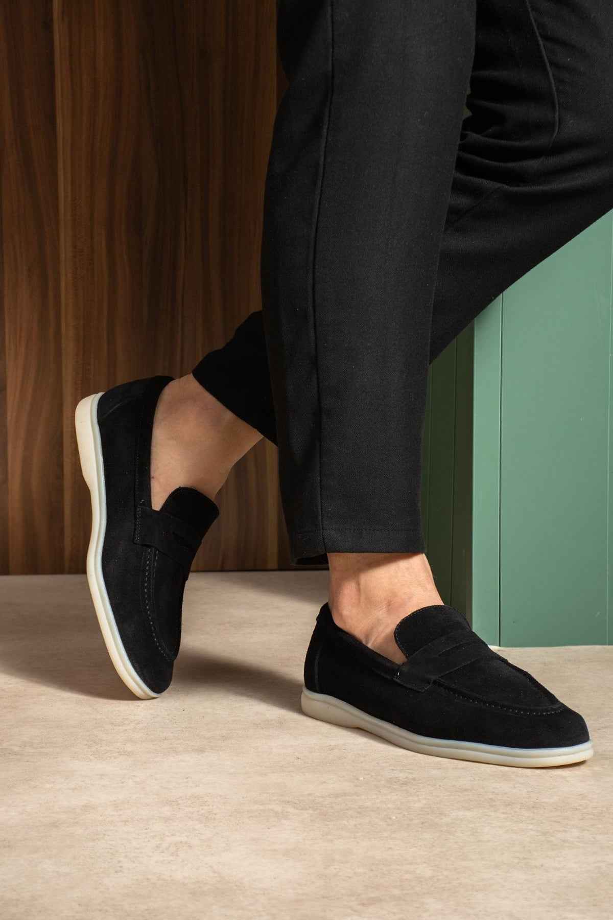Black slip-on loafers with low profile and white sole edge