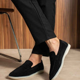 Black slip-on loafers, front angle, white rubber sole