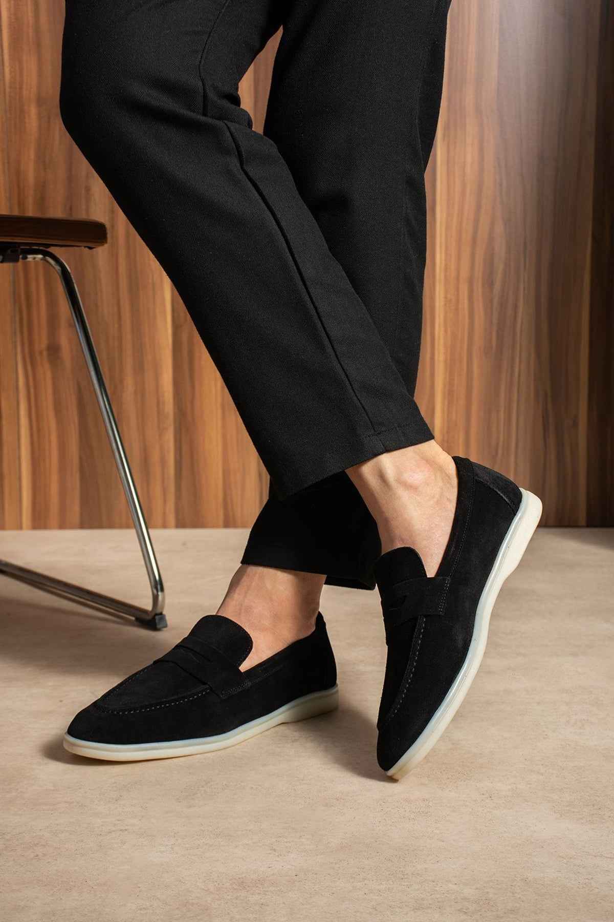 Black slip-on loafers, front angle, white rubber sole