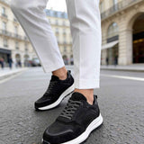 Men's black leather low-top sneakers with lace-up and white sole