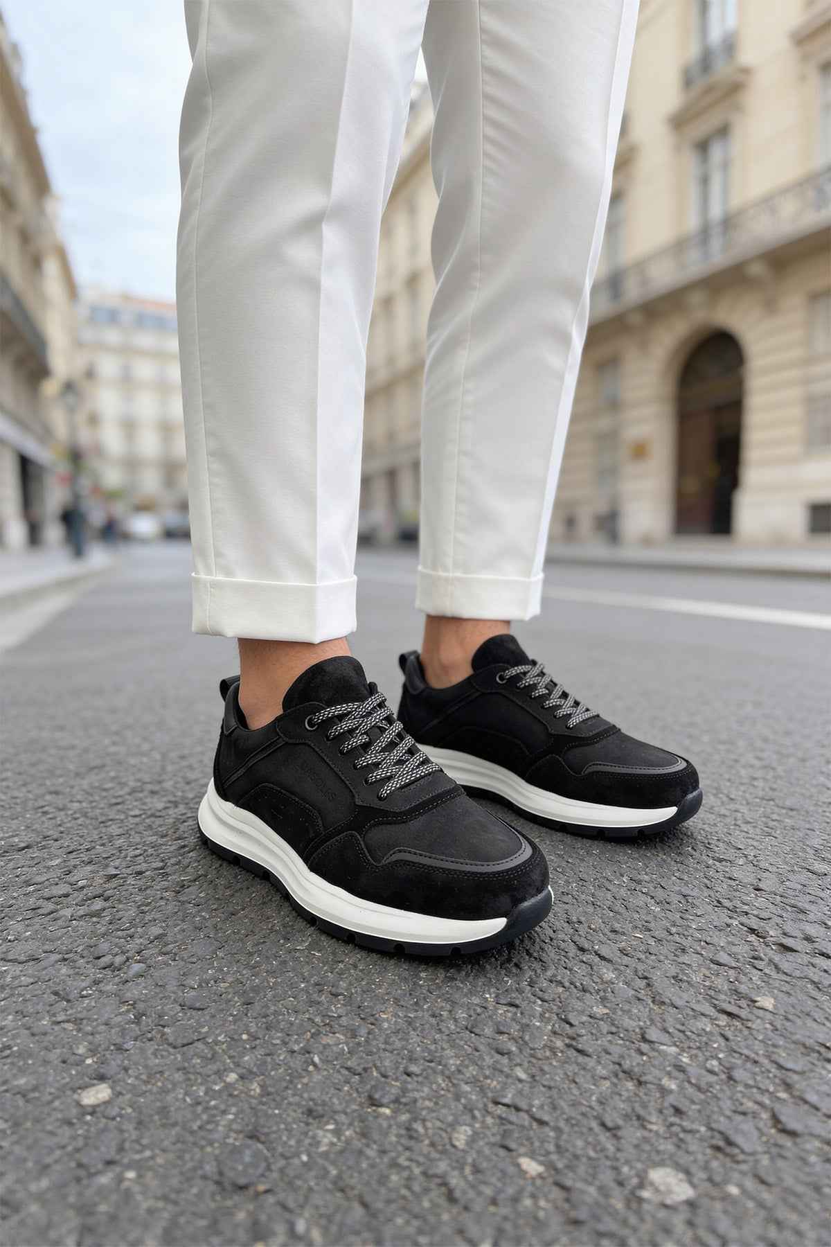 Men's black leather lace-up sneakers with white sole, side view
