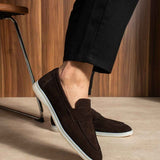Men's genuine leather loafers, dark brown slip-on with white outsole edge, angled view.