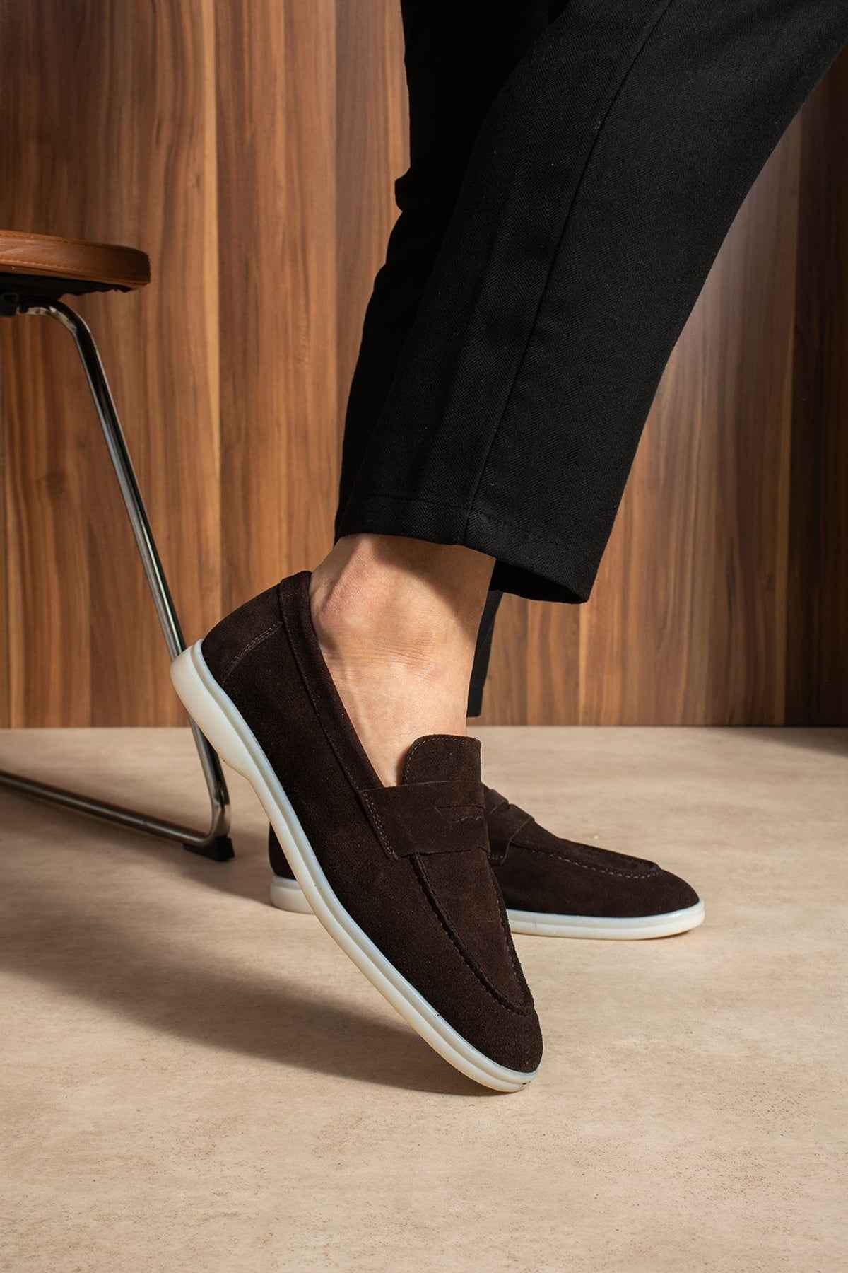 Men's genuine leather loafers, dark brown slip-on with white outsole edge, angled view.