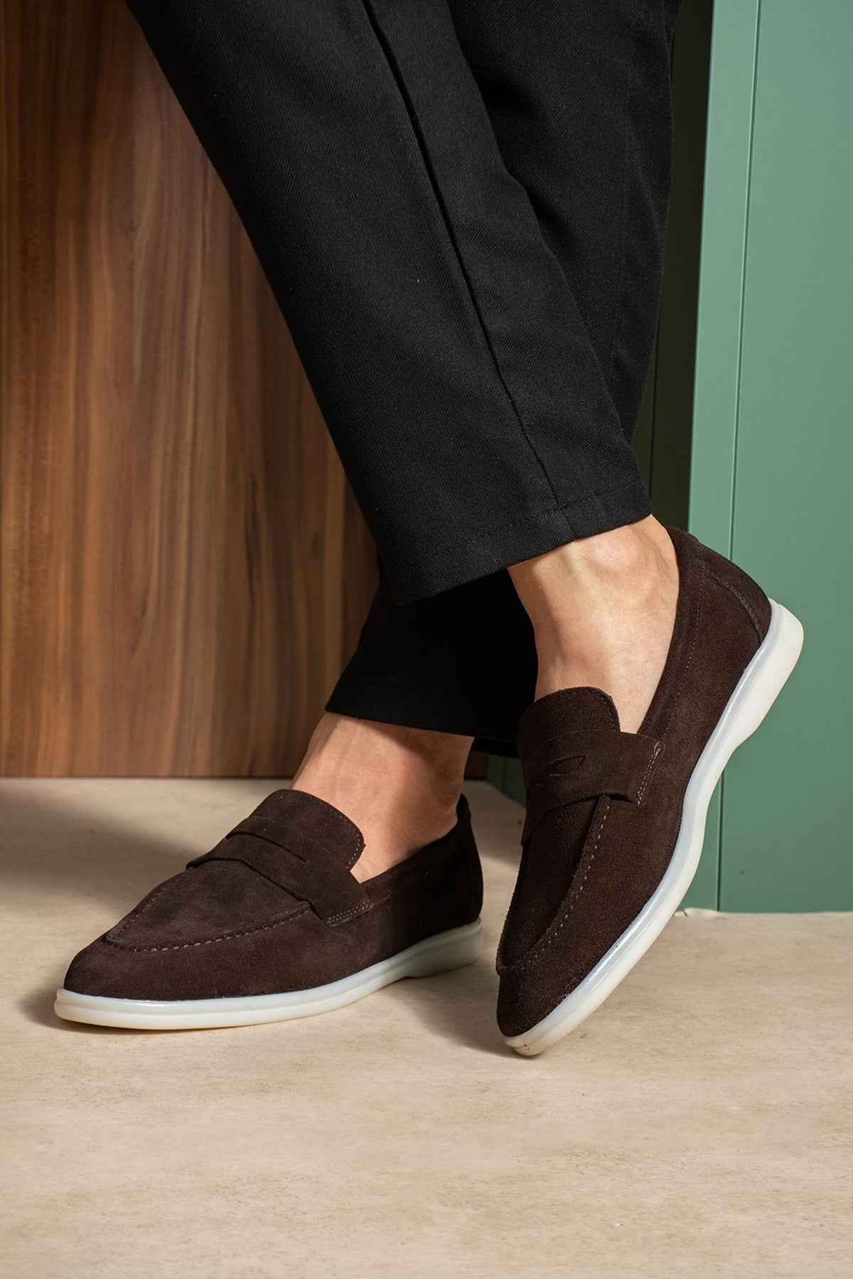 Men's genuine leather loafers, dark brown slip-on with white sole edge, side view.