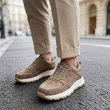 Brown leather sneakers with lace-up closure and thick white sole