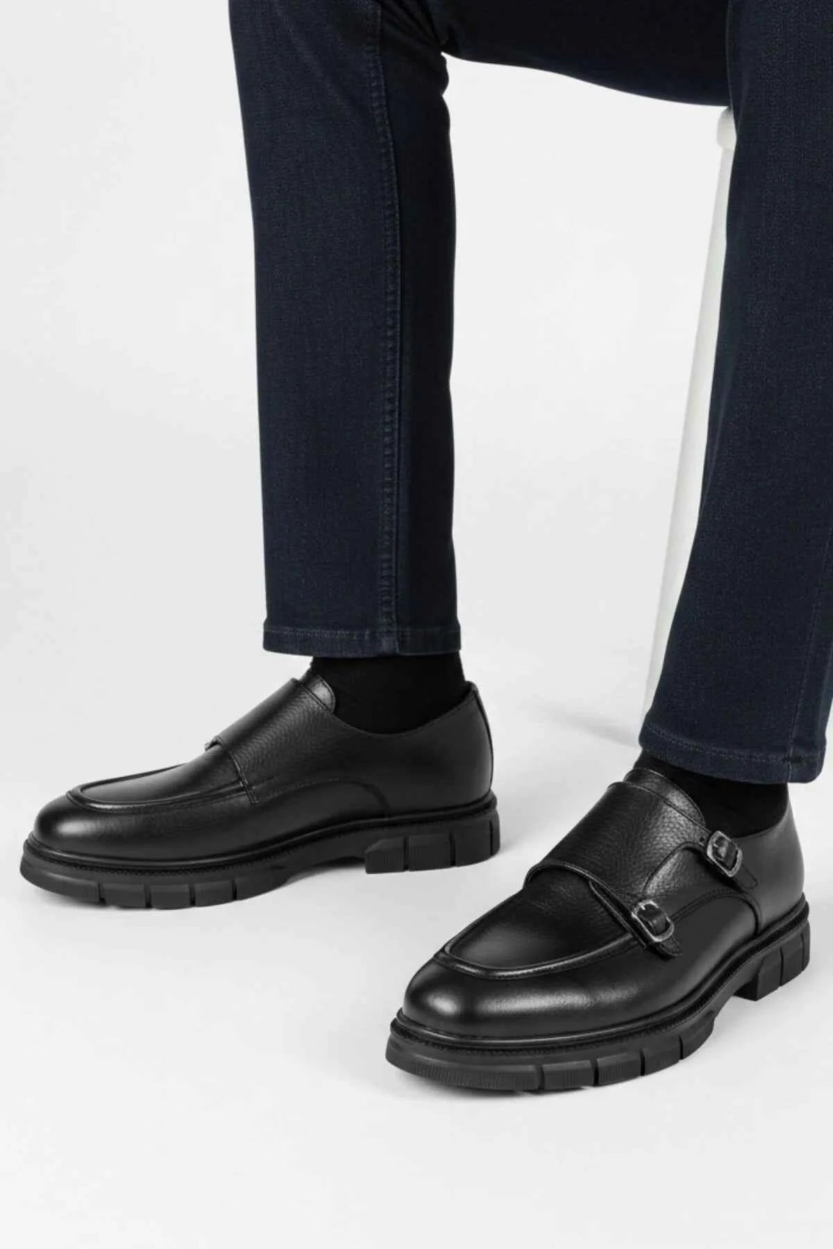 Black leather monk strap shoes with double side buckles, worn with jeans