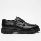 Black leather monk strap shoe side view with two metal buckles