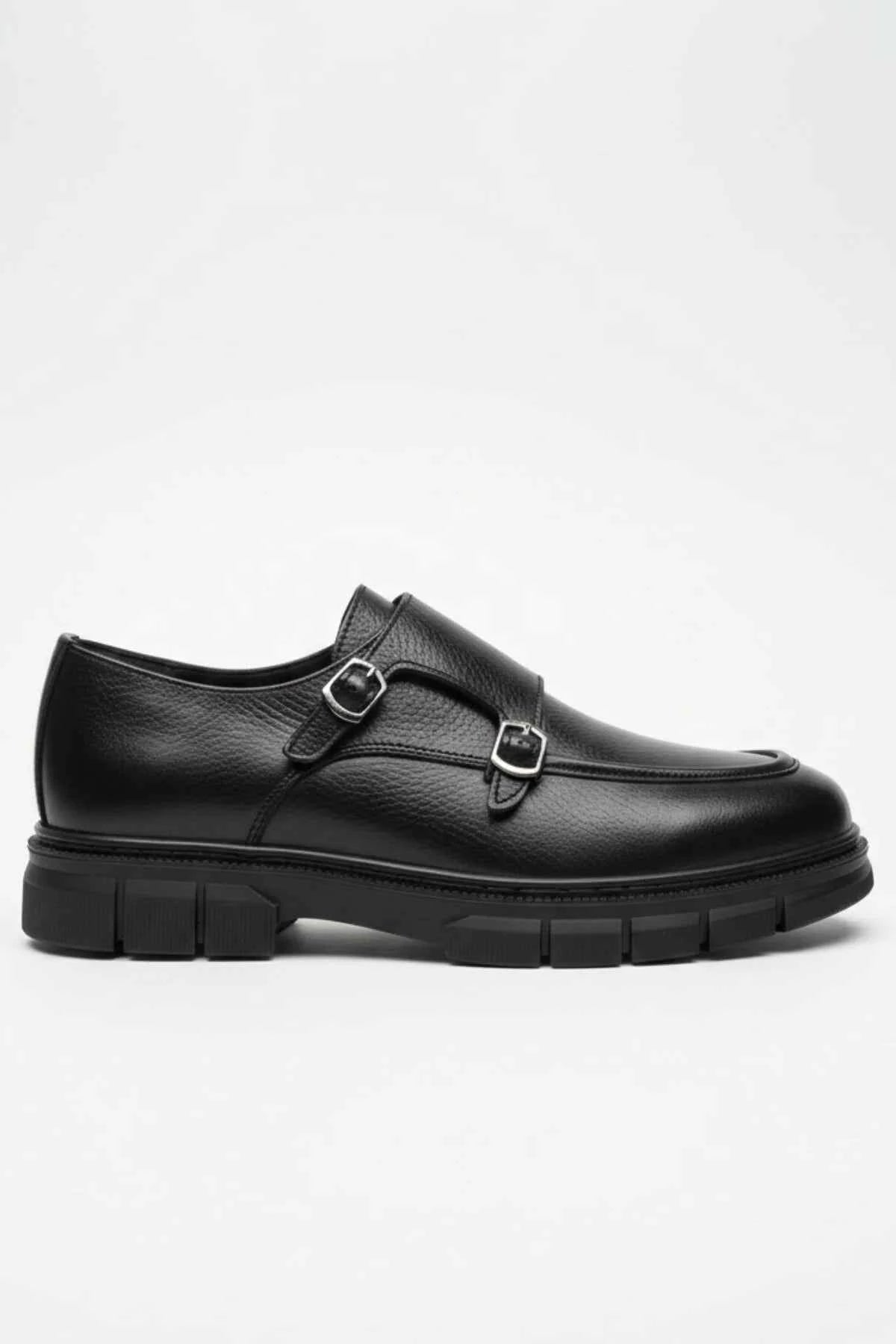 Black leather monk strap shoe side view with two metal buckles