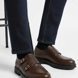 Brown leather double-buckle loafers with black treaded sole