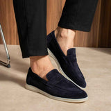 Navy leather slip-on loafers with low profile white rubber sole