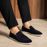 Navy leather loafers slip-on style with white sole, side view