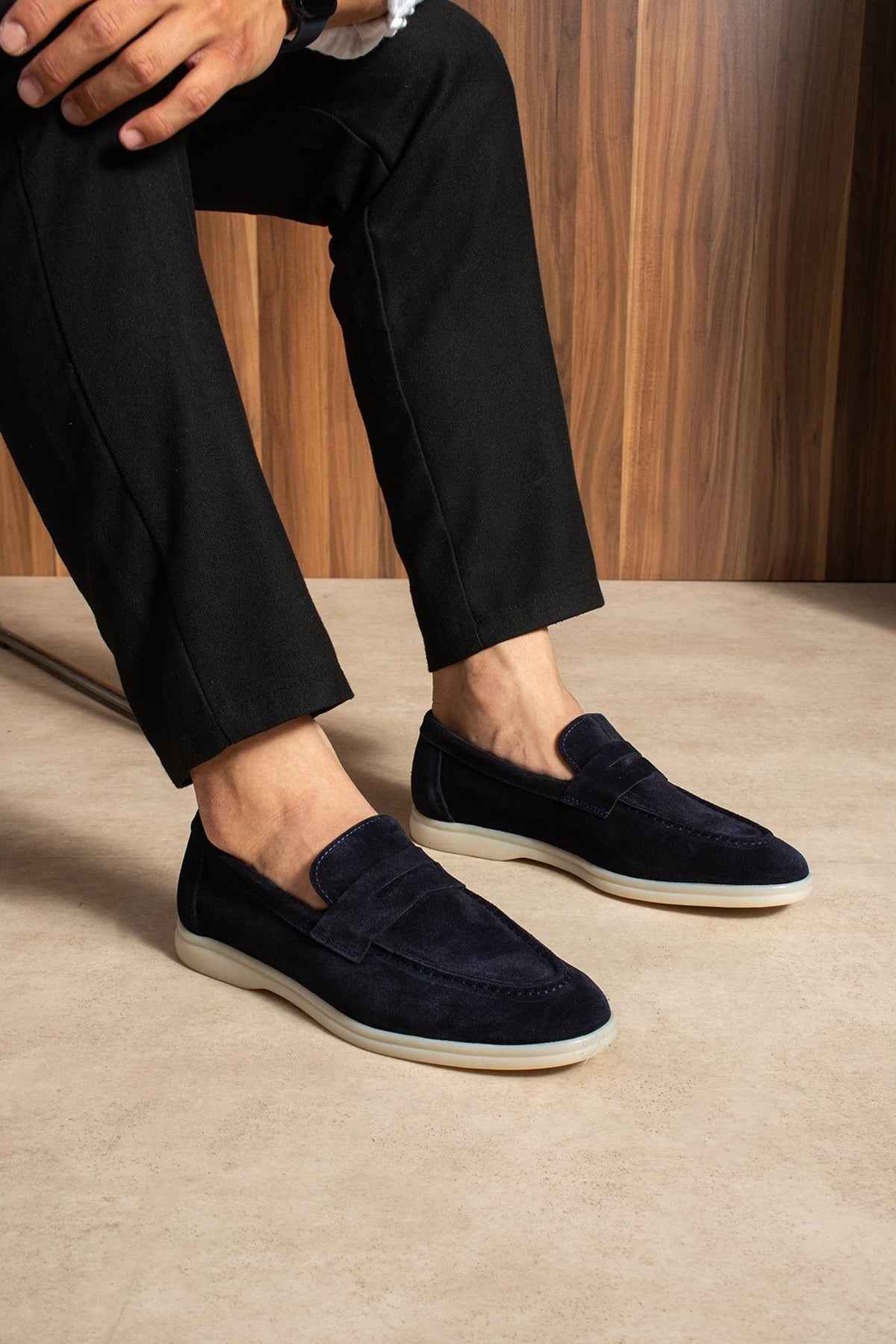 Navy leather loafers slip-on style with white sole, side view