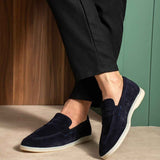 Navy leather slip-on loafers with textured upper and white rubber sole