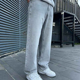 Light gray baggy jeans, side view, relaxed wide-leg fit and belt loops