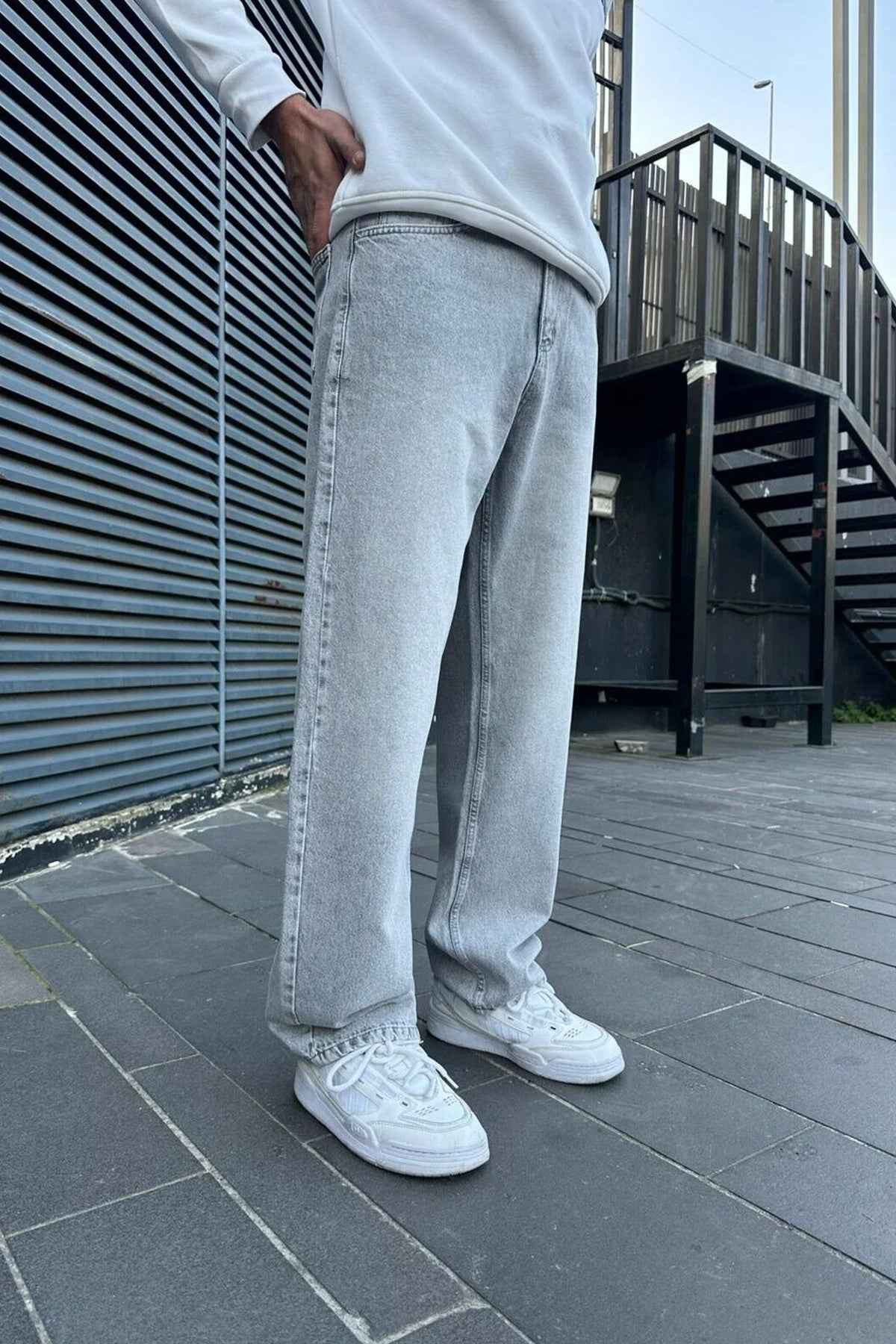 Light gray baggy jeans, side view, relaxed wide-leg fit and belt loops