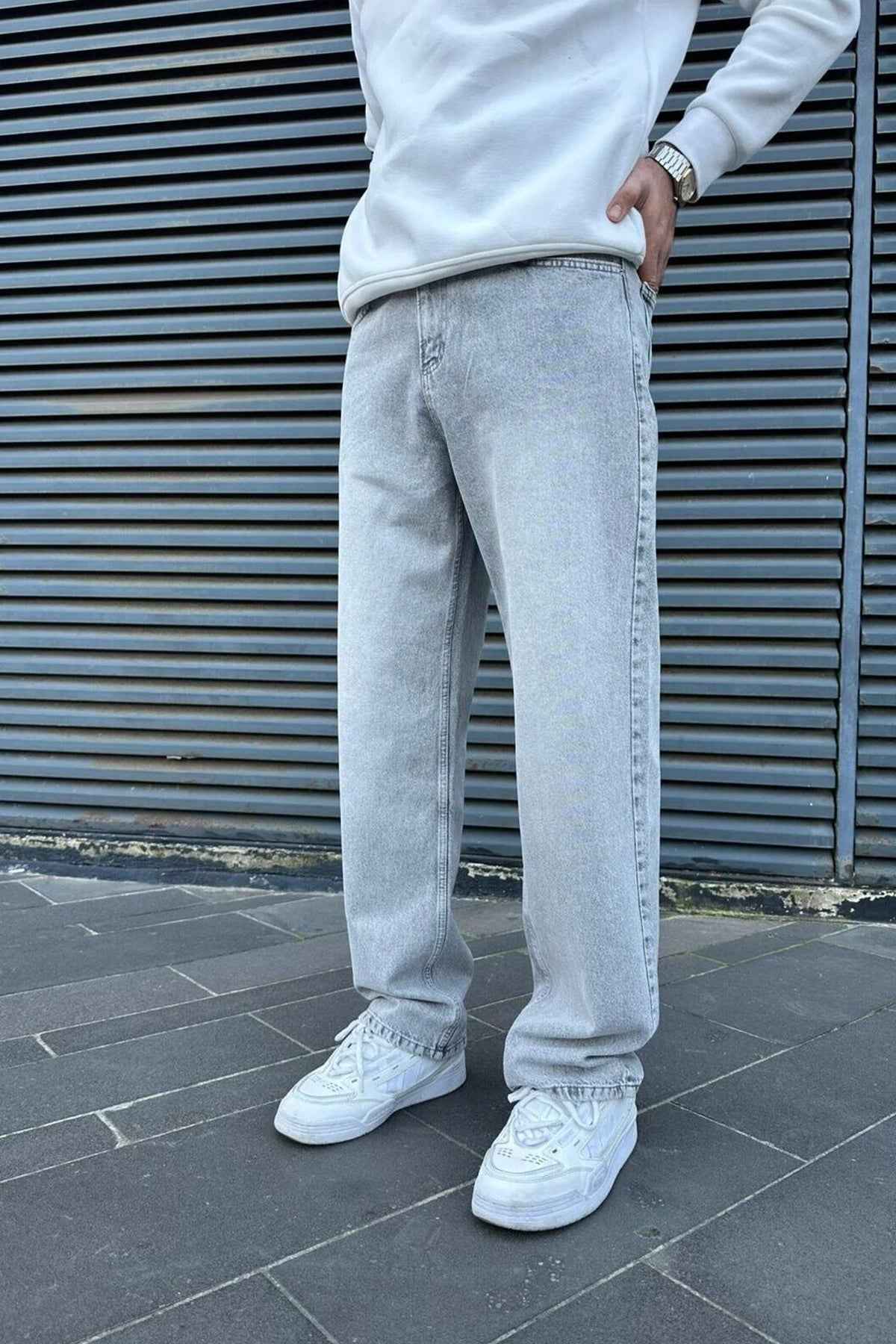 Light gray baggy jeans with relaxed straight legs, belt loops and stitched seams