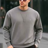 Men's gray crewneck sweatshirt with long sleeves and small chest logo