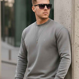 Men's gray crewneck sweatshirt with ribbed cuffs and small chest logo
