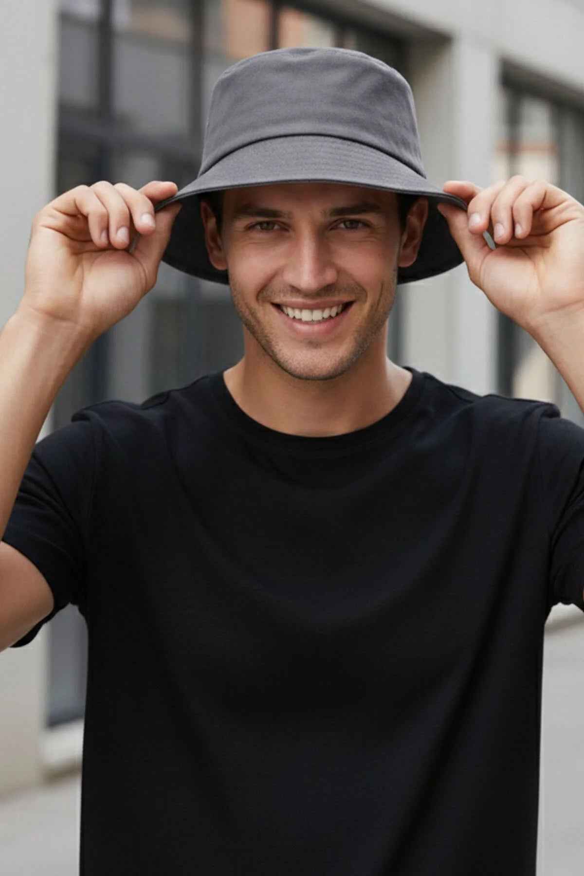 Gray bucket hat held by brim, wide round crown