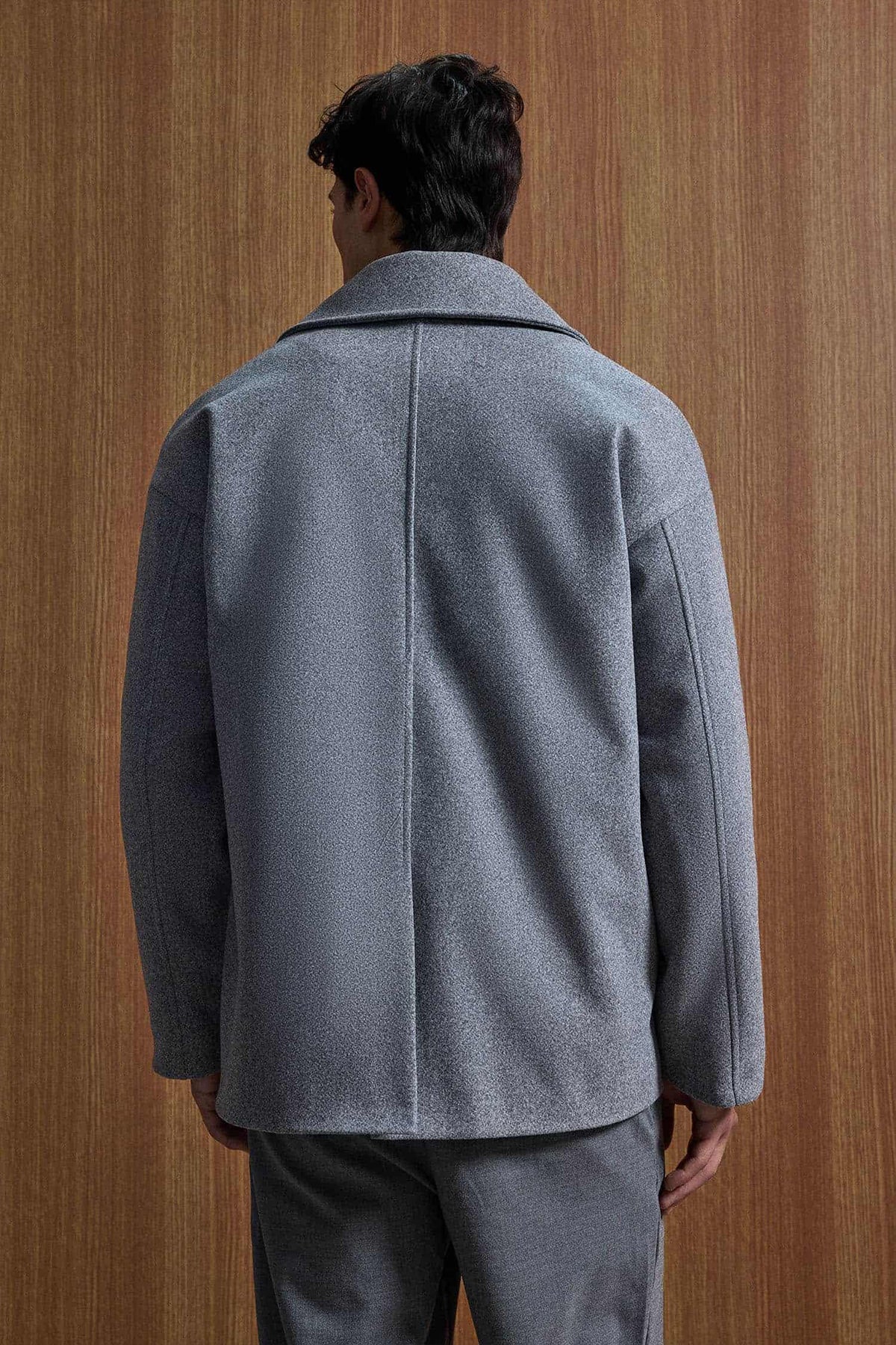 Gray oversized double-breasted coat back view with center seam and full sleeves